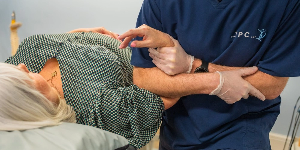 Person holding knee in pain